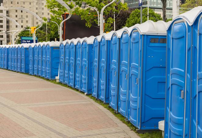 a row of portable restrooms set up for a large athletic event, allowing participants and spectators to easily take care of their needs in Bellmawr